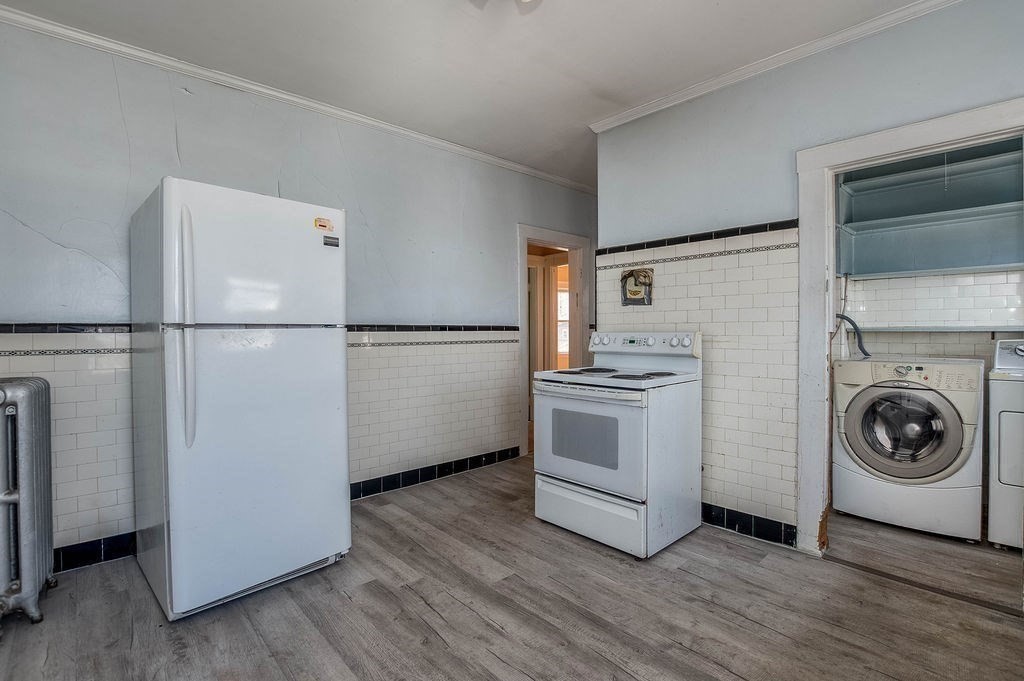 73 Westbourne Street Boston, MA 02131 - Photo 9 of 41 a white refrigerator freezer and a stove sitting inside of a kitchen