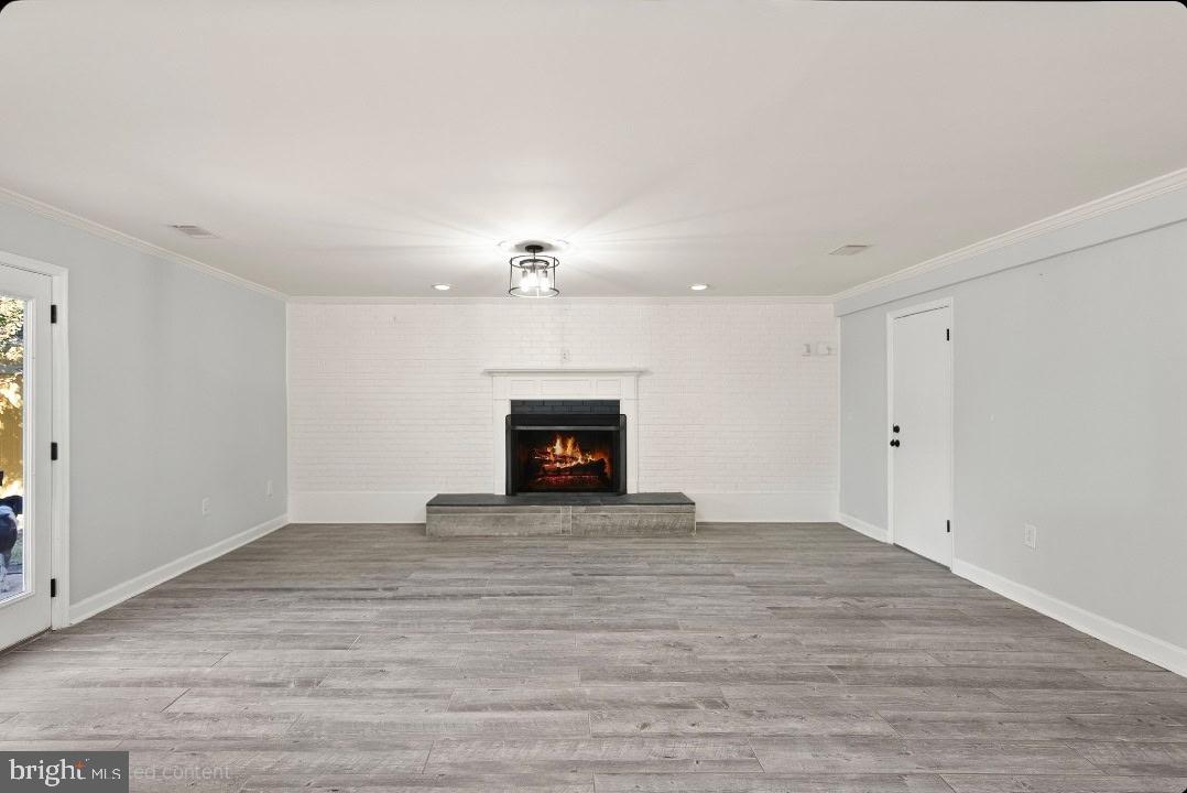 4006 Novar Drive Chantilly, VA 20151 - Photo 12 of 49 a view of an empty room with wooden floor fireplace and a window