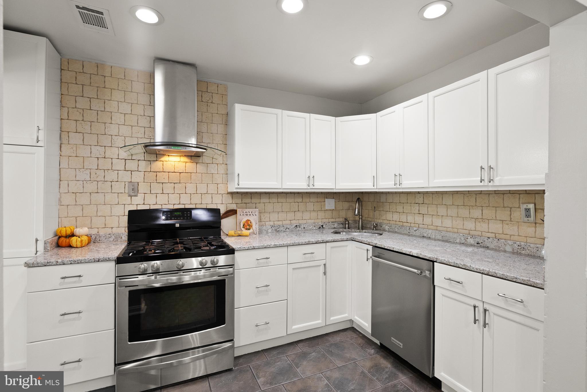 4006 Novar Drive Chantilly, VA 20151 - Photo 6 of 49 a kitchen with stainless steel appliances granite countertop a sink and a stove