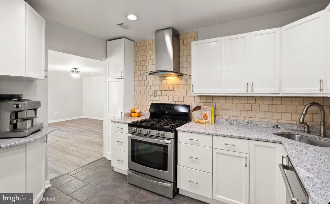 4006 Novar Drive Chantilly, VA 20151 - Photo 10 of 49 a kitchen with granite countertop white cabinets and appliances