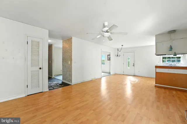 a view of a kitchen with a sink and a refrigerator