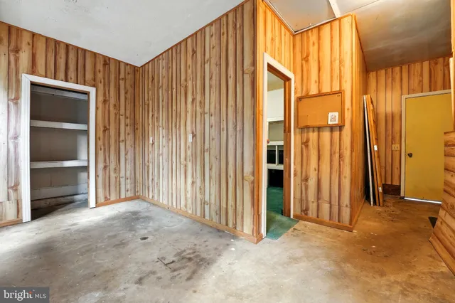 an empty room with a window and a bathroom