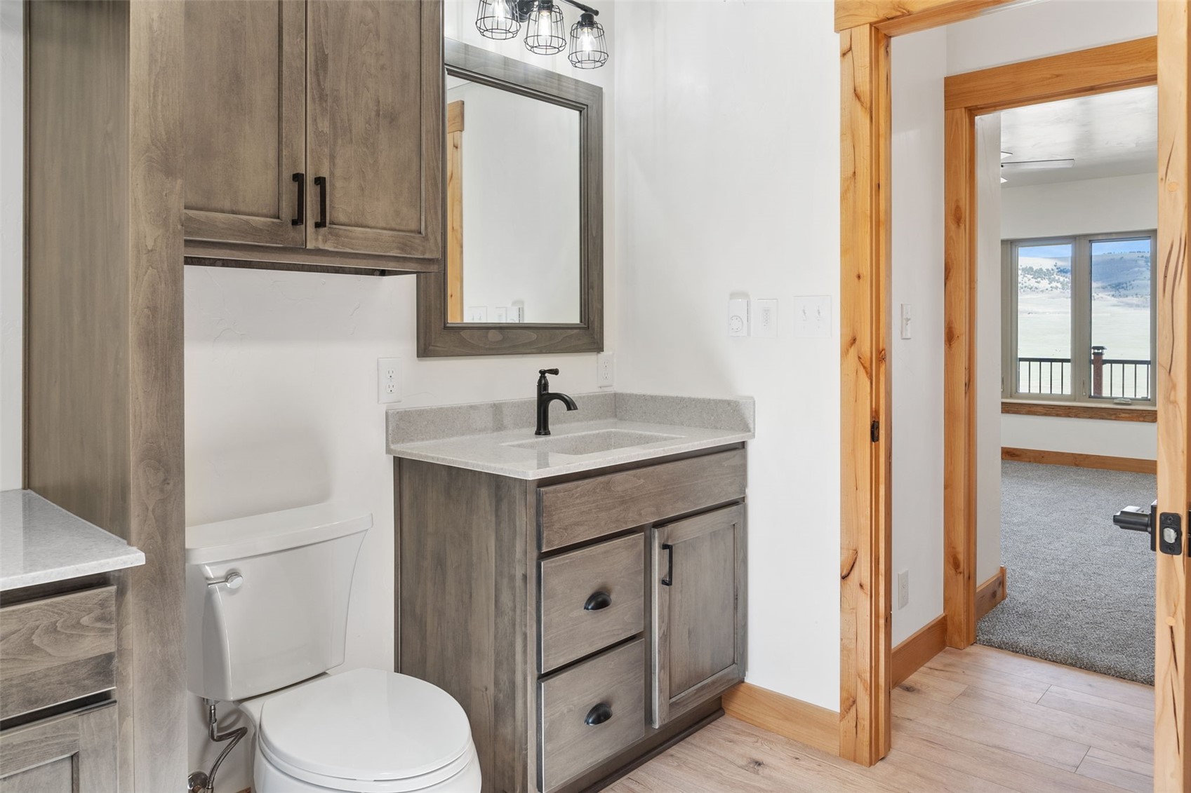 3415 Redhill Road Fairplay, CO 80440 - Photo 35 of 50 a bathroom with a toilet a sink a mirror and vanity