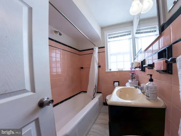 a bathroom with a sink a mirror and a bathtub