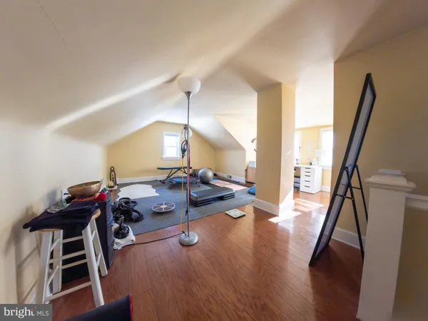 a view of a room with wooden floor table and chairs