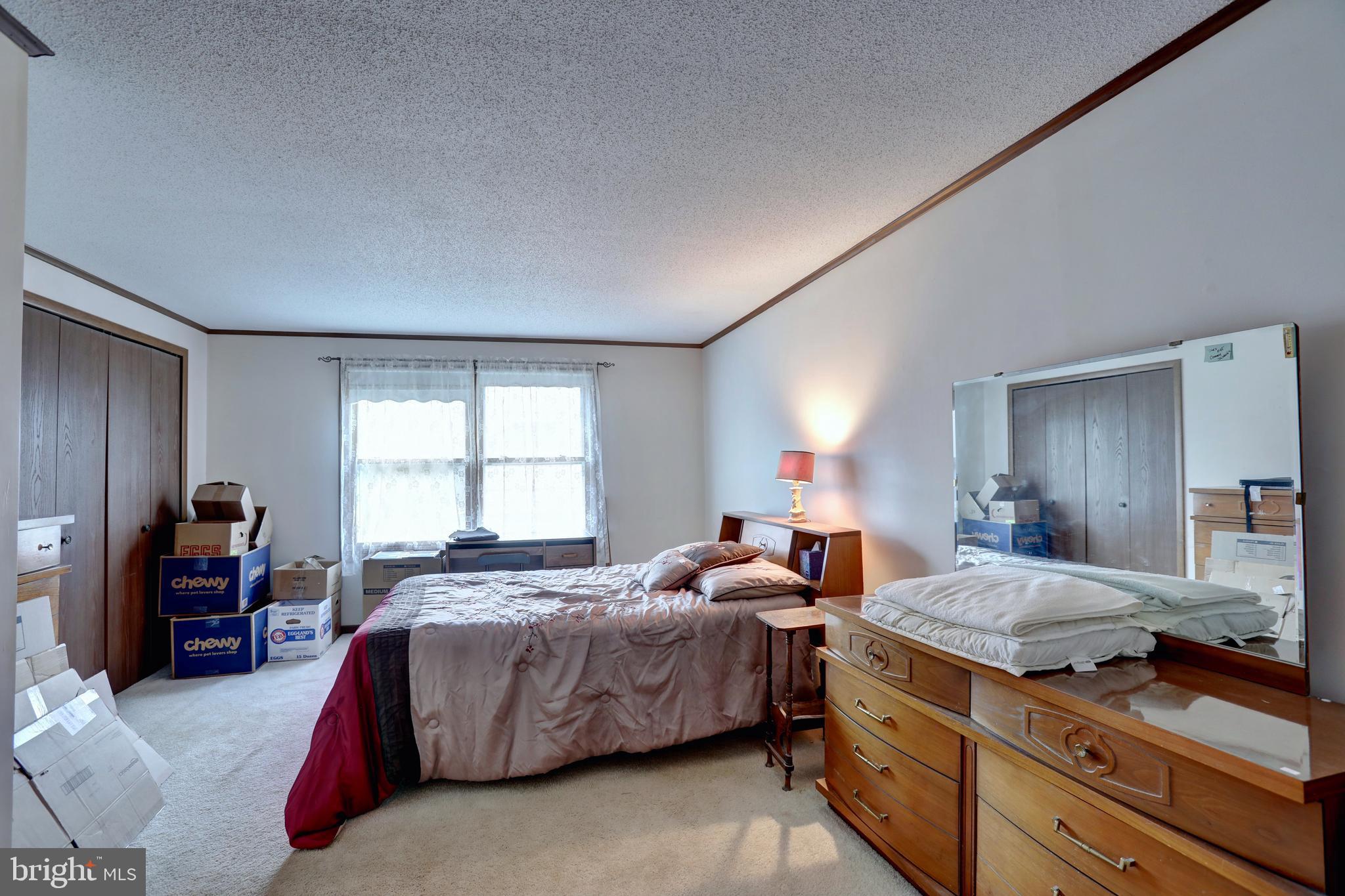 816 Utterback Store Road Great Falls, VA 22066 - Photo 11 of 28 a bedroom with a bed and dresser