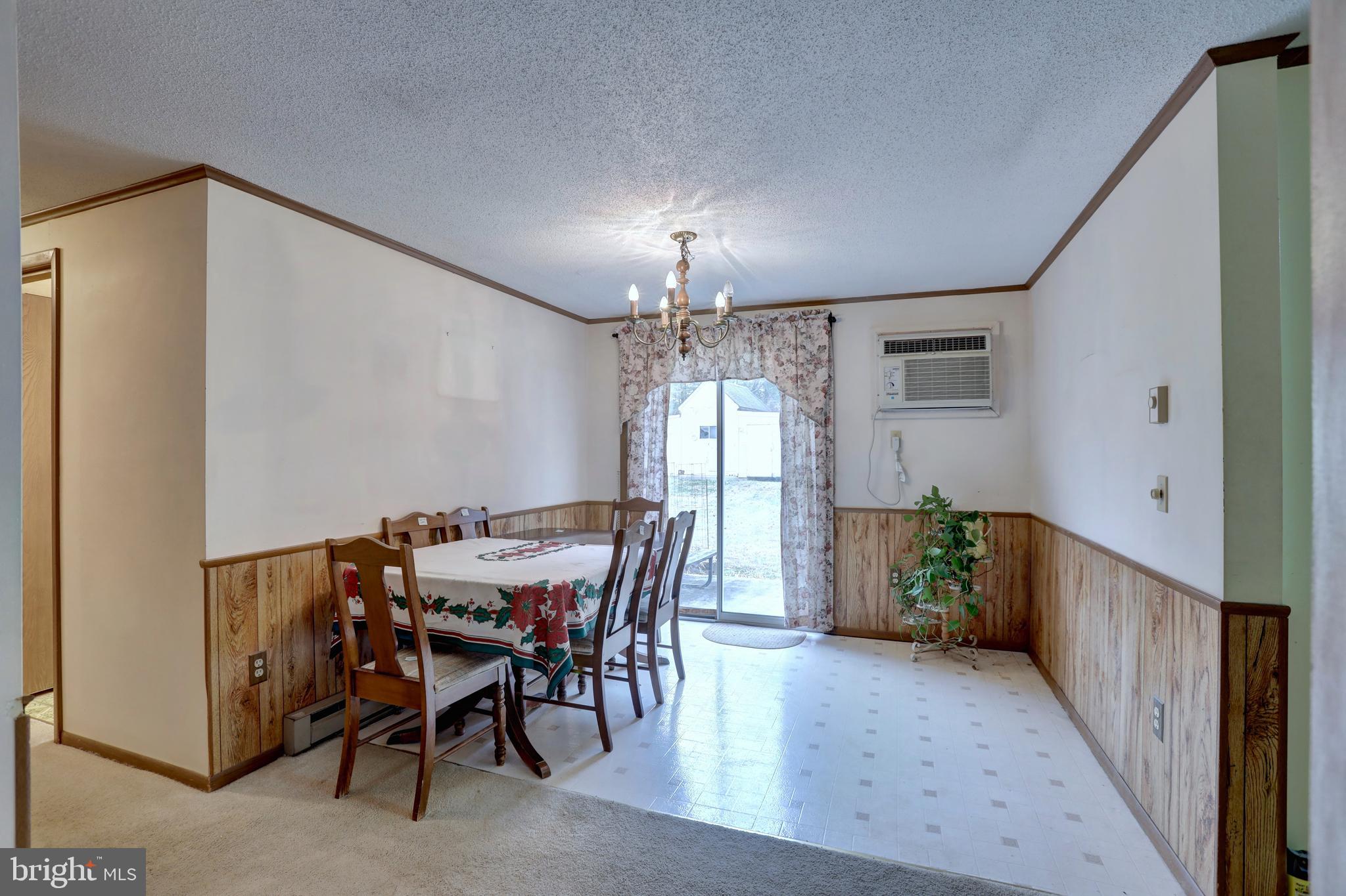 816 Utterback Store Road Great Falls, VA 22066 - Photo 4 of 28 a view of a dining room with furniture and chandelier