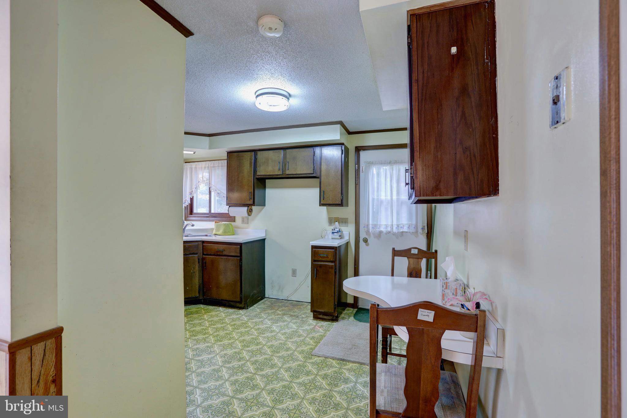 816 Utterback Store Road Great Falls, VA 22066 - Photo 5 of 28 a kitchen with stainless steel appliances granite countertop a sink and a refrigerator