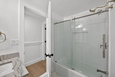 a bathroom with a shower and a bath tub