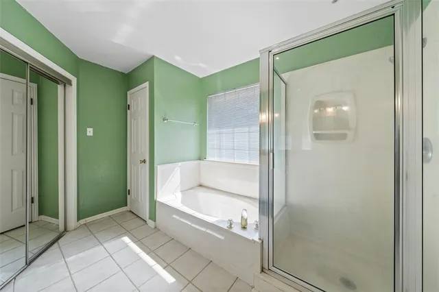 a bathroom with a bathtub and a shower