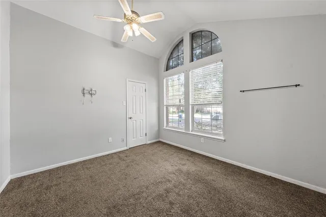 a view of empty room with ceiling fan