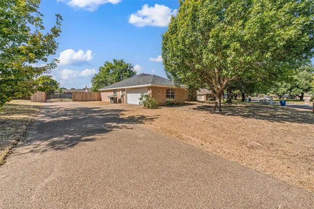 a view of a house with a yard and tree s