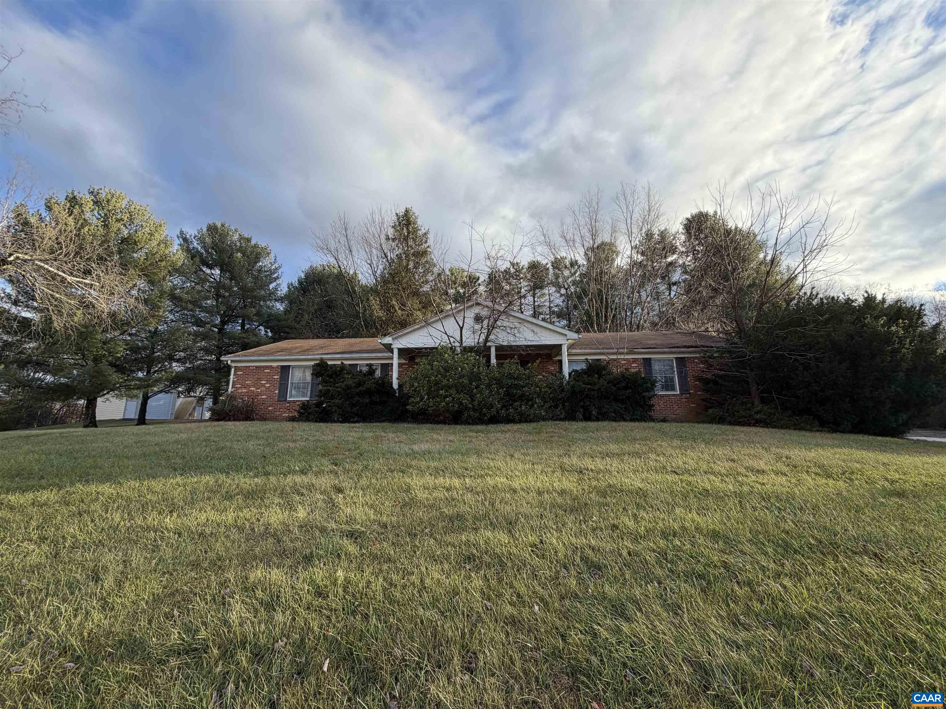 a front view of a house with a garden