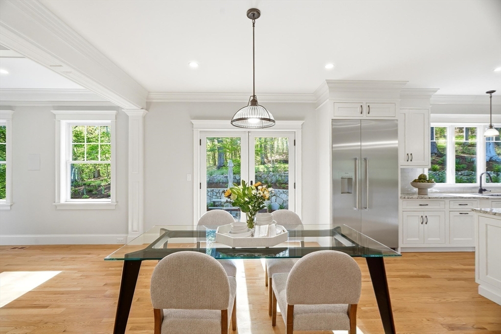6 Flintlock Road Lexington, MA 02420 - Photo 6 of 39 a dining room with furniture a chandelier and wooden floor