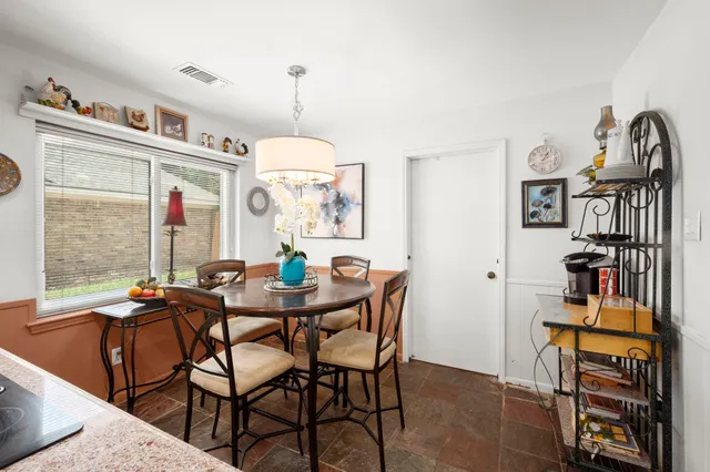 a view of a dining room with furniture and a window