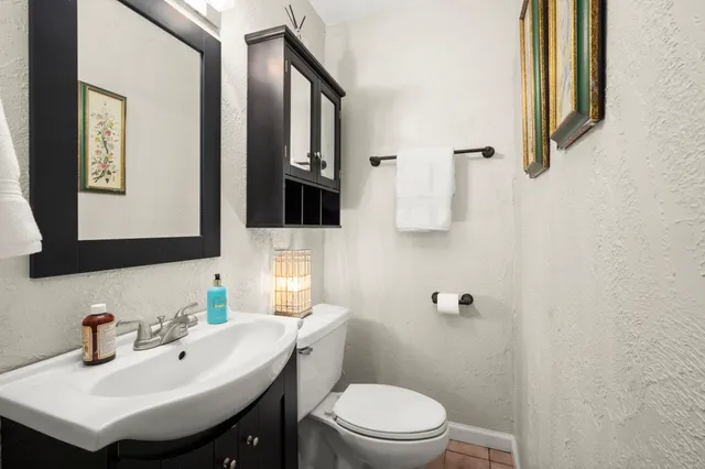 a bathroom with a sink toilet and mirror