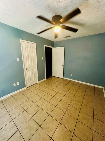 a view of a livingroom with an empty space and a floor to ceiling window