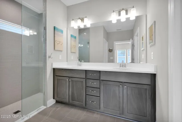 a bathroom with a bath tub sink mirror and vanity