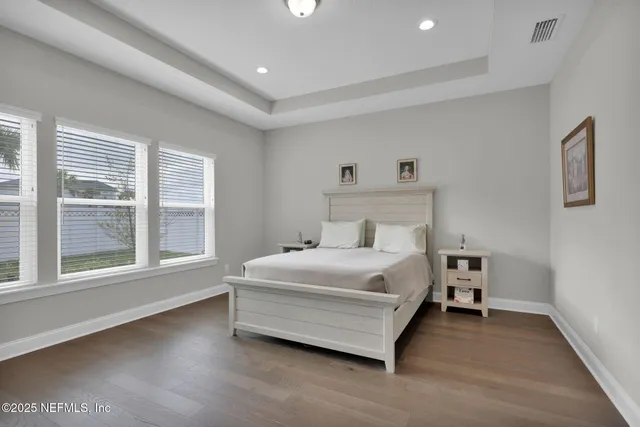 a bed room with a bed and a large window