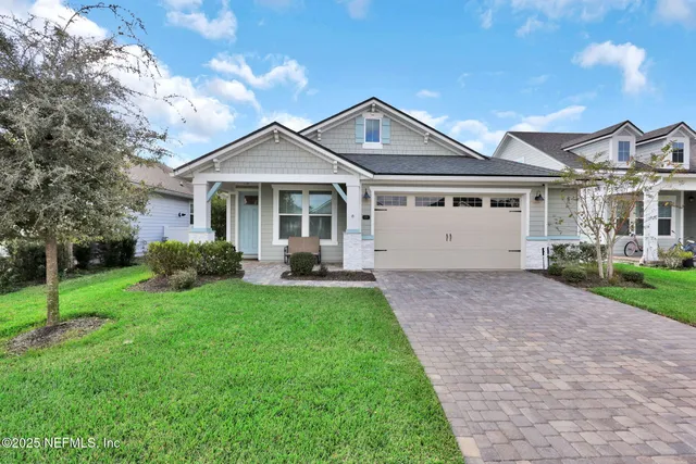 a front view of a house with a yard and trees