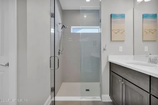 a bathroom with a bath tub sink mirror and vanity