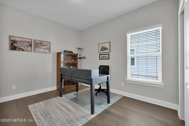 a view of a workspace with furniture and a window