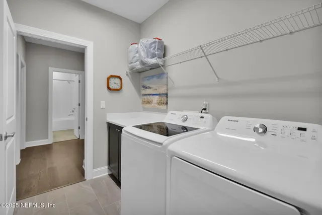 a view of storage and utility room with washer and dryer