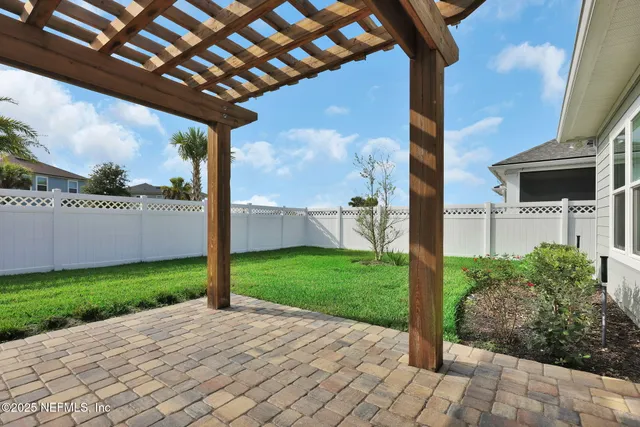 a view of a backyard with brick wall and a building