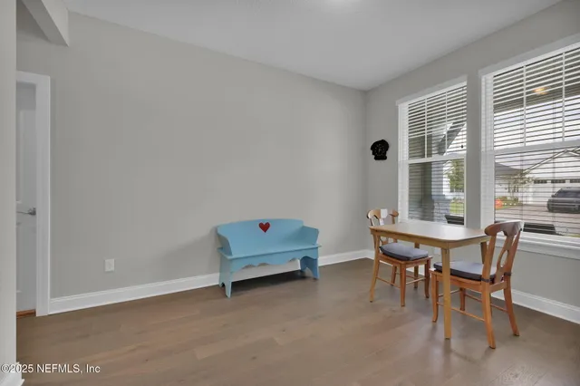 a dining room with furniture and window