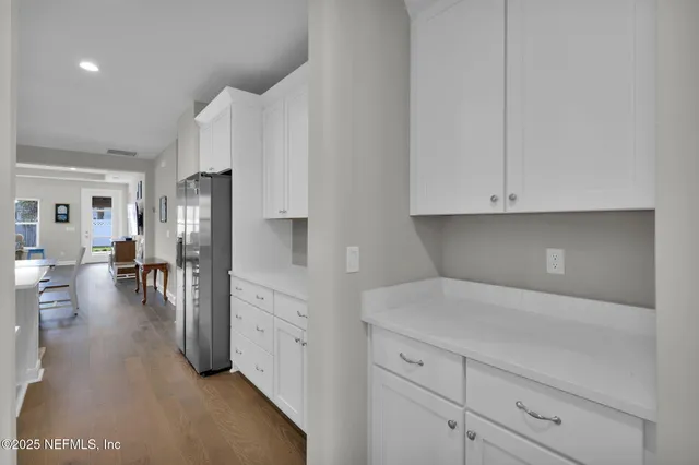 a kitchen with cabinets and a refrigerator
