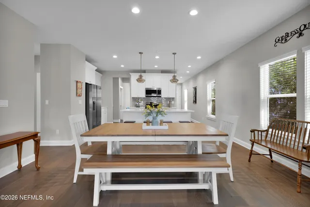 a view of kitchen with refrigerator dining table and chairs