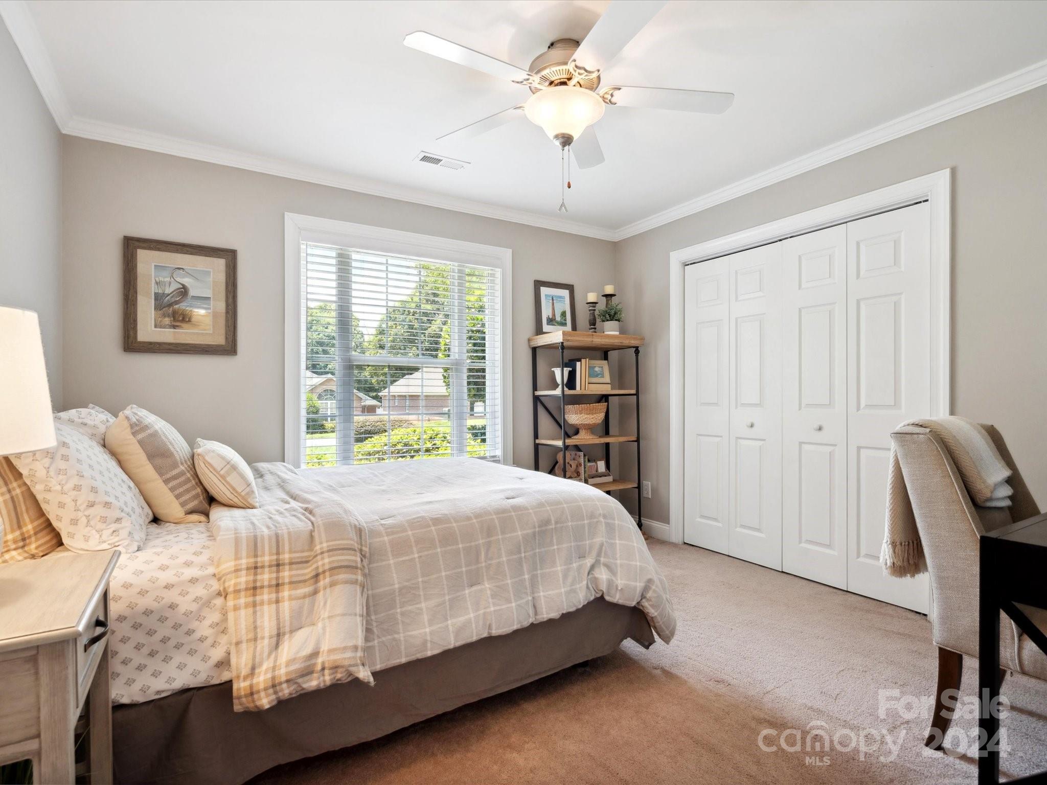 166 Zimmerman Drive Fort Mill, SC 29708 - Photo 16 of 30 a bedroom with a bed a table and a book shelf