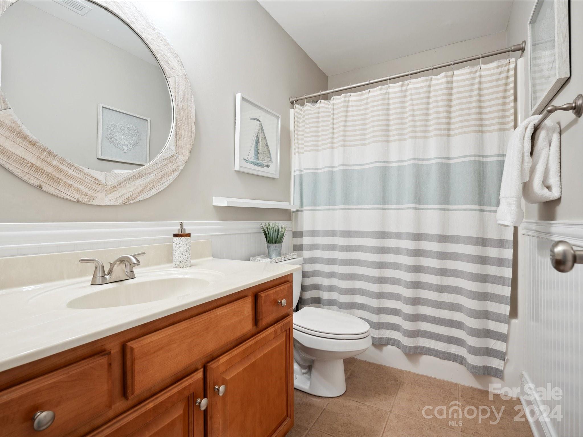 166 Zimmerman Drive Fort Mill, SC 29708 - Photo 18 of 30 a bathroom with a sink a toilet and shower curtain