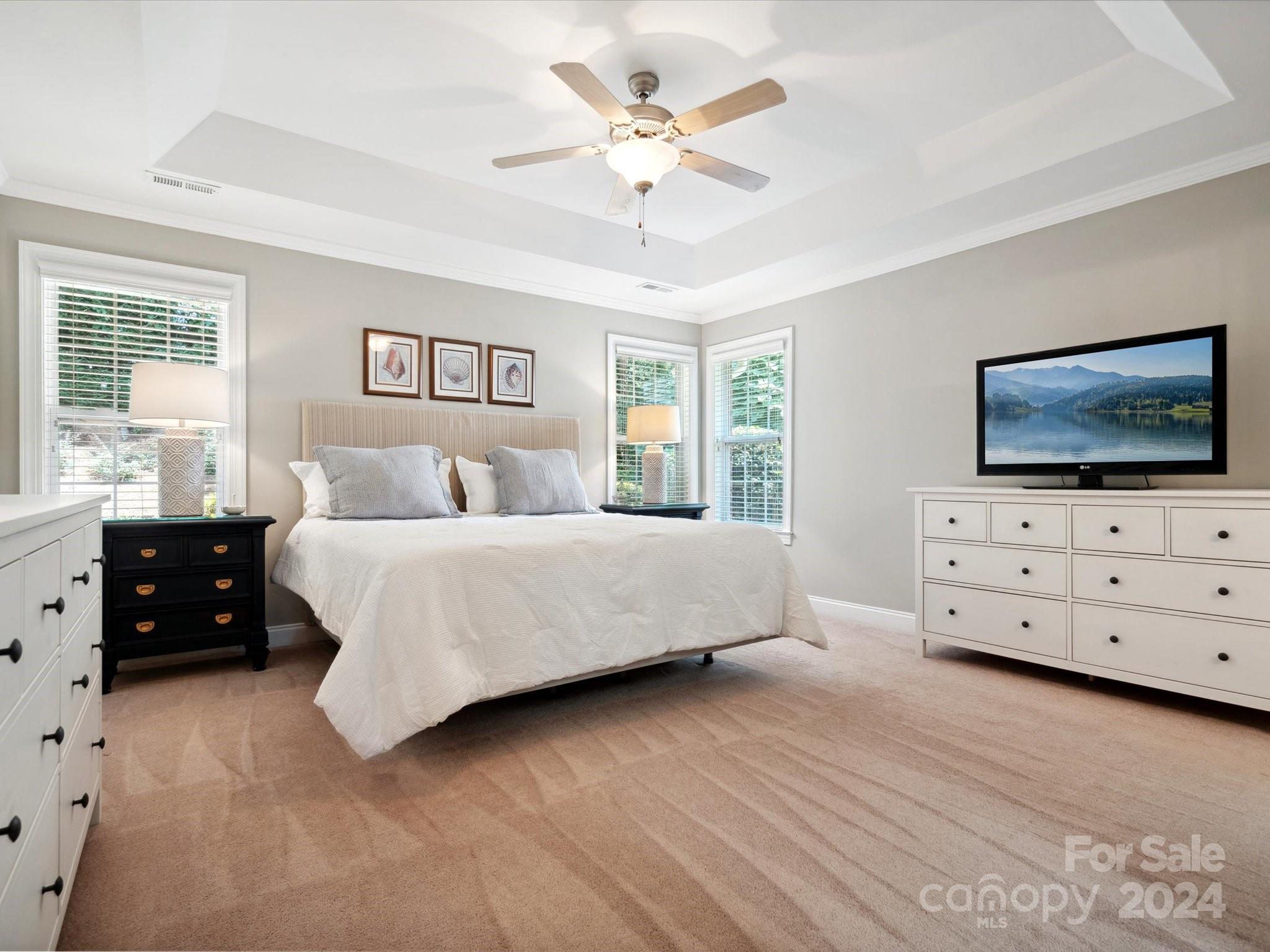 166 Zimmerman Drive Fort Mill, SC 29708 - Photo 19 of 30 a bedroom with a bed and a flat tv screen on dresser
