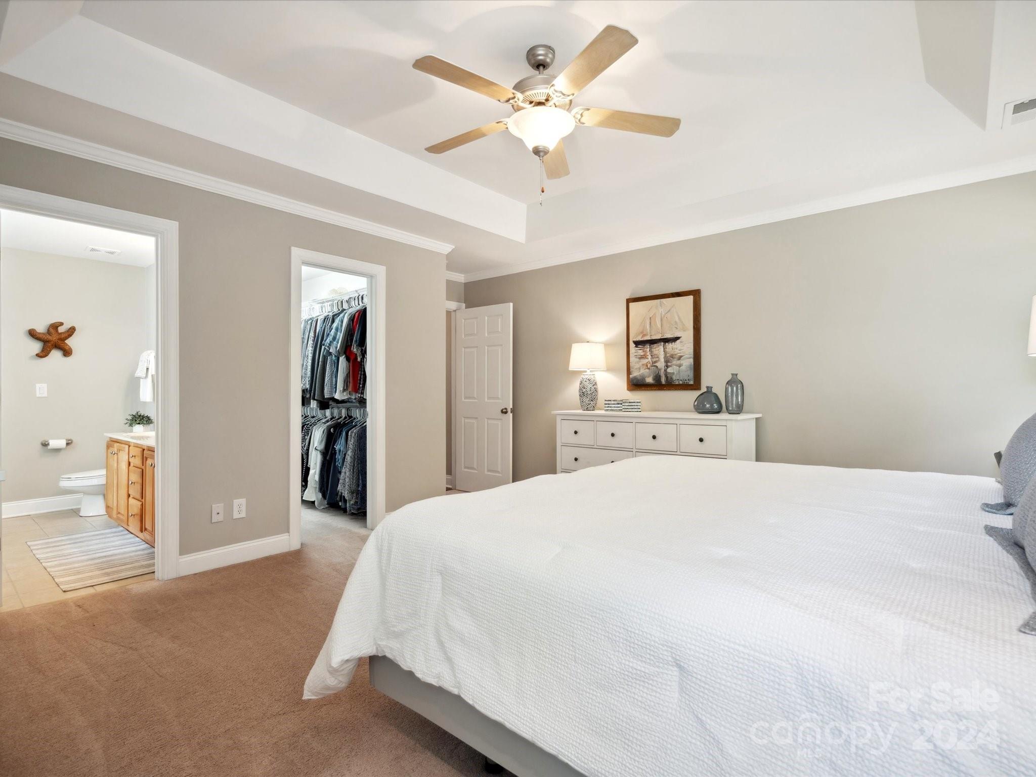 166 Zimmerman Drive Fort Mill, SC 29708 - Photo 20 of 30 a spacious bedroom with a bed and a ceiling fan