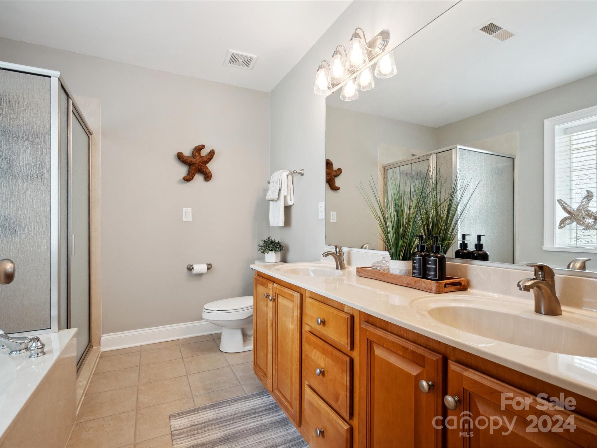 166 Zimmerman Drive Fort Mill, SC 29708 - Photo 21 of 30 a spacious bathroom with a double vanity sink toilet and shower