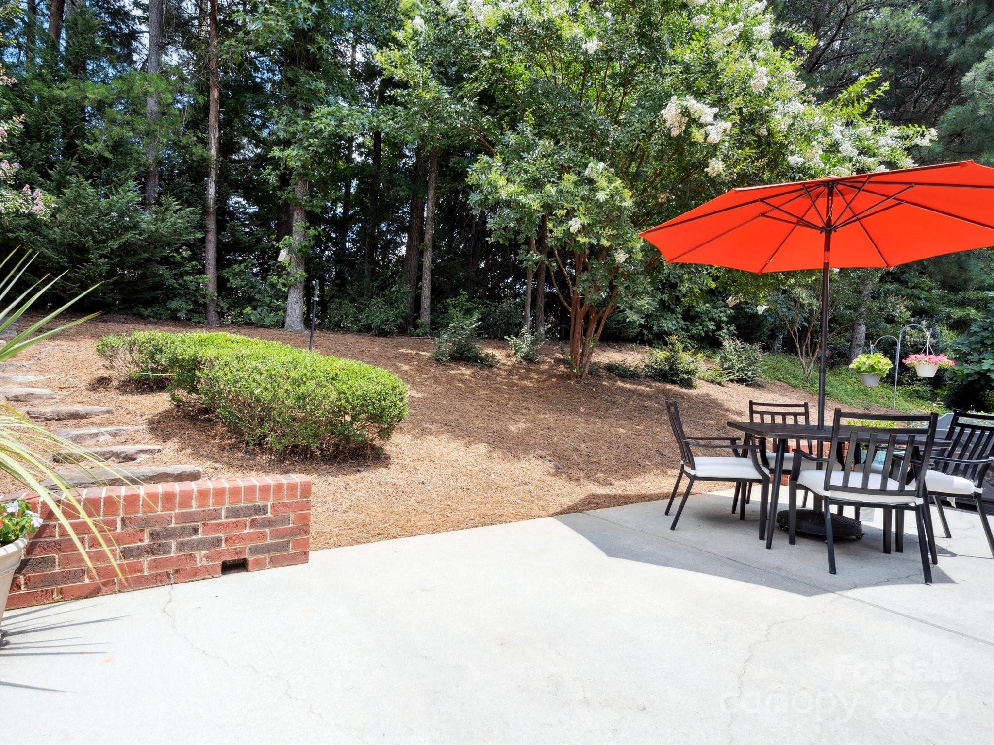 166 Zimmerman Drive Fort Mill, SC 29708 - Photo 26 of 30 a view of a backyard with a patio and fire pit