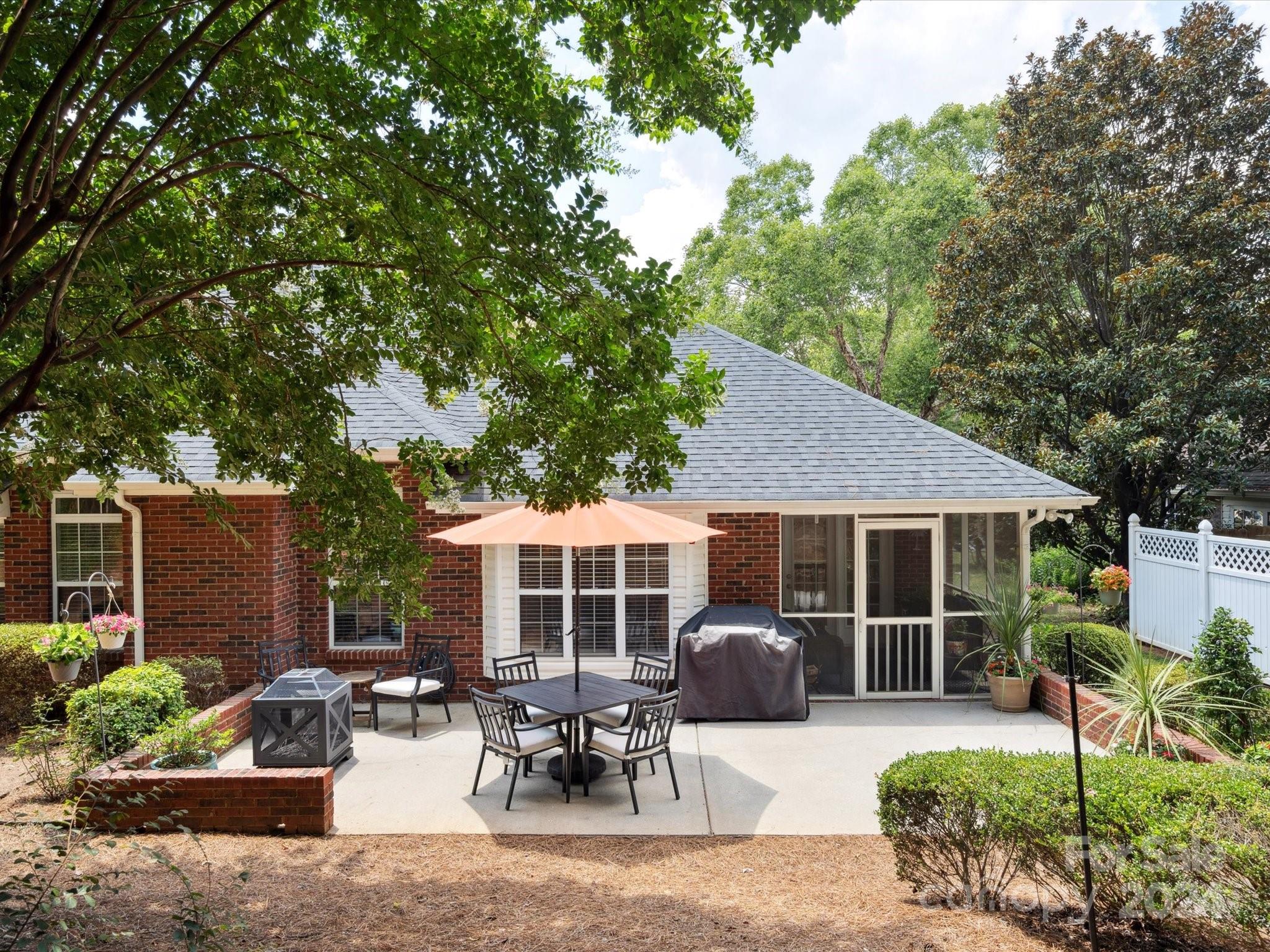 166 Zimmerman Drive Fort Mill, SC 29708 - Photo 30 of 30 a view of a house with backyard sitting area and garden