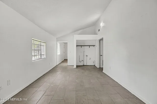 an empty room with a empty space and windows