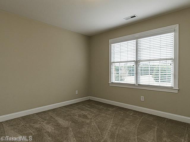 5403 Gray Leigh Drive Oak Ridge, NC 27310 - Photo 11 of 16 3rd Bedroom. The 3rd bedroom (11 7" x 10 9") receives lots of light from the large windows. Features neutral paint and carpet.