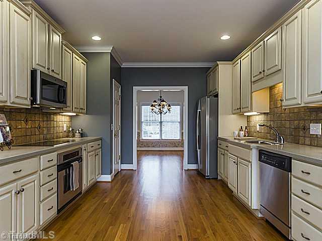 5403 Gray Leigh Drive Oak Ridge, NC 27310 - Photo 4 of 16 Kitchen. Beautiful galley kitchen has solid surface counter tops, plenty of cabinet and stainless steel appliances.