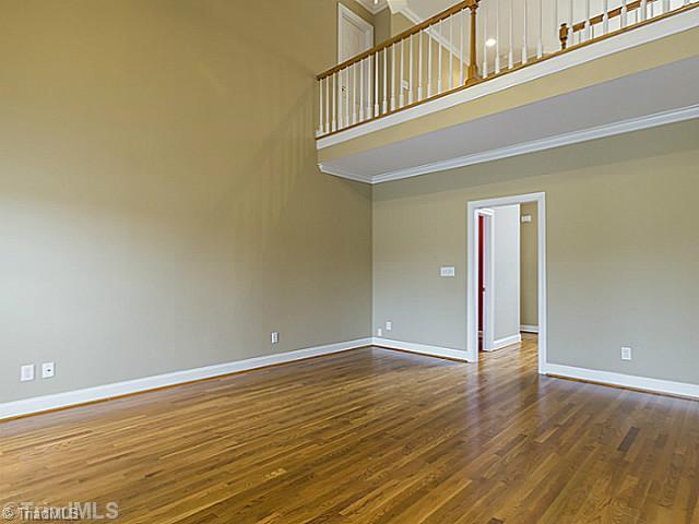 5403 Gray Leigh Drive Oak Ridge, NC 27310 - Photo 7 of 16 Living Room. There are beautiful hardwood floors and a balcony over looking the living room.