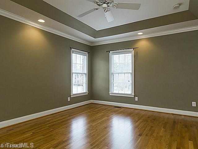 5403 Gray Leigh Drive Oak Ridge, NC 27310 - Photo 8 of 16 Master Bedroom. Master bedroom 16 7" x 13 8" features beautiful hardwood floors, tray ceiling, with crown molding and a ceiling fan.