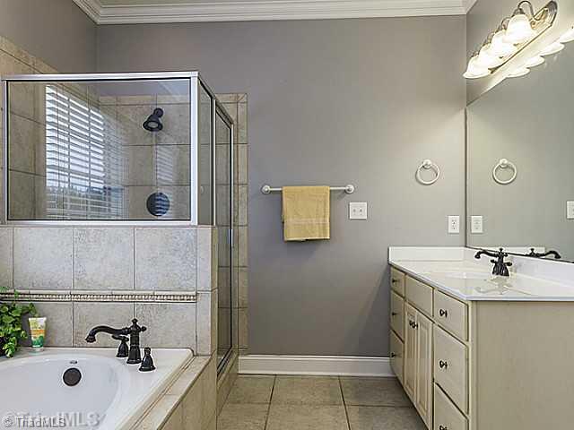 5403 Gray Leigh Drive Oak Ridge, NC 27310 - Photo 9 of 16 Master Bath/Spa. The master bathroom features a garden tub, separate vanity areas and a