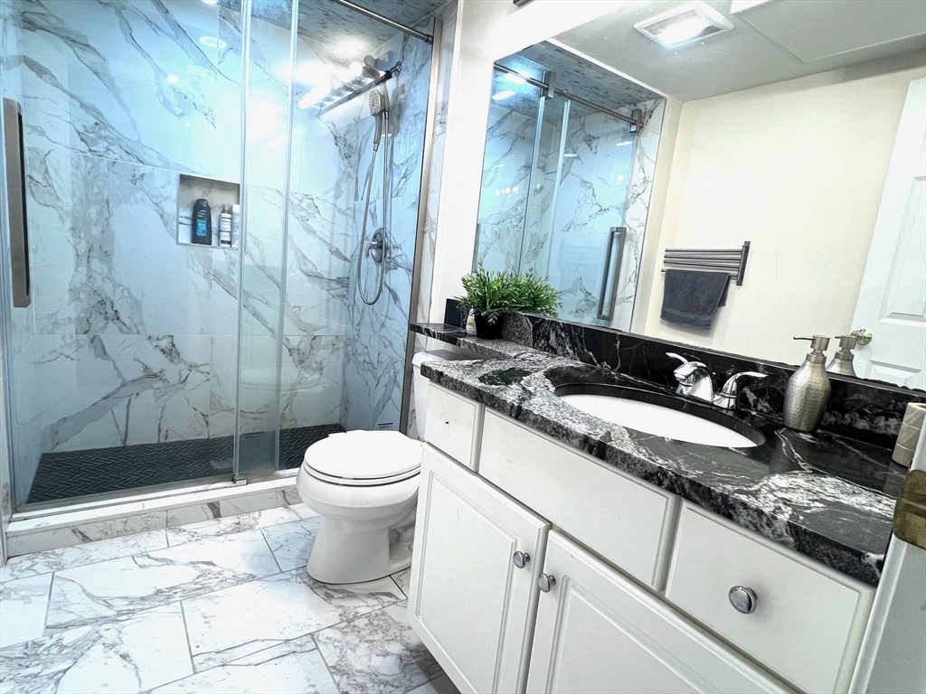 42 Evergreen Circle, Unit 42 Canton, MA 02021 - Photo 15 of 26 a bathroom with a granite countertop sink toilet and shower