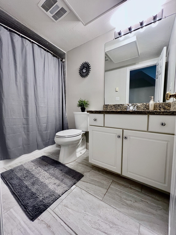 42 Evergreen Circle, Unit 42 Canton, MA 02021 - Photo 19 of 26 a bathroom with a sink a toilet and mirror