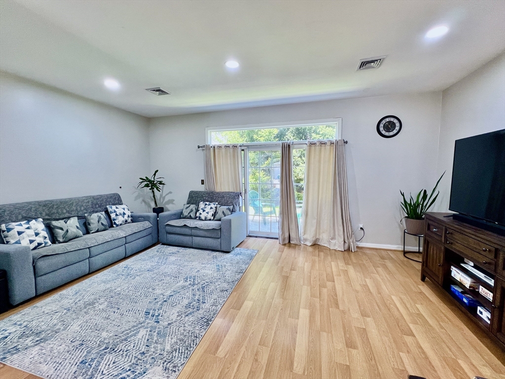 42 Evergreen Circle, Unit 42 Canton, MA 02021 - Photo 2 of 26 a spacious bedroom with a bed and a flat screen television
