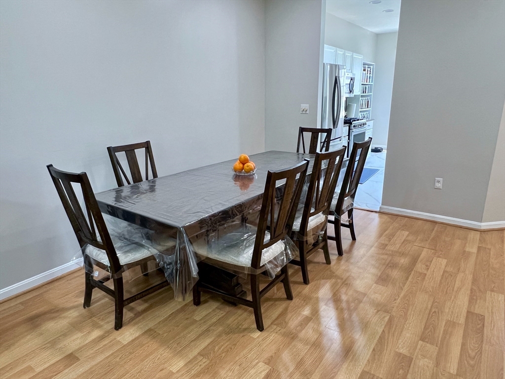 42 Evergreen Circle, Unit 42 Canton, MA 02021 - Photo 4 of 26 a view of a dining room with furniture and wooden floor