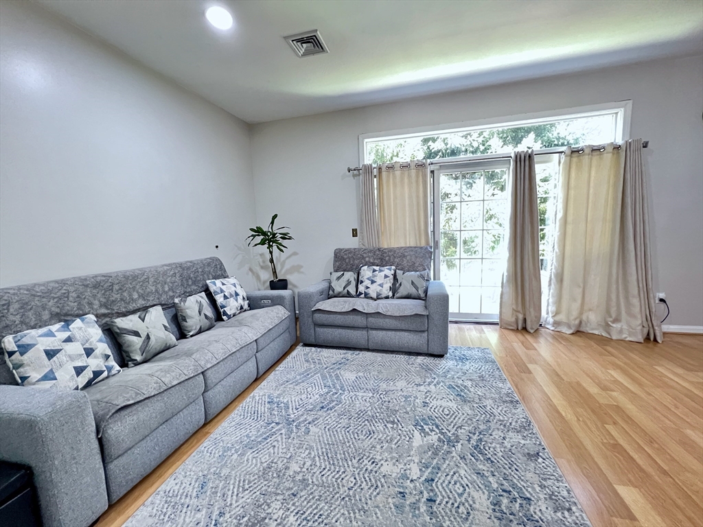 42 Evergreen Circle, Unit 42 Canton, MA 02021 - Photo 5 of 26 a living room with furniture and a large window