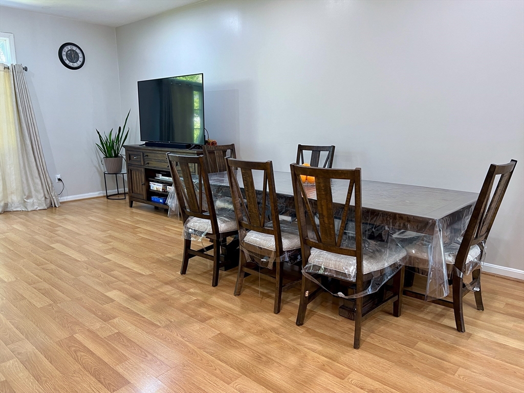 42 Evergreen Circle, Unit 42 Canton, MA 02021 - Photo 6 of 26 a dining room with furniture and wooden floor